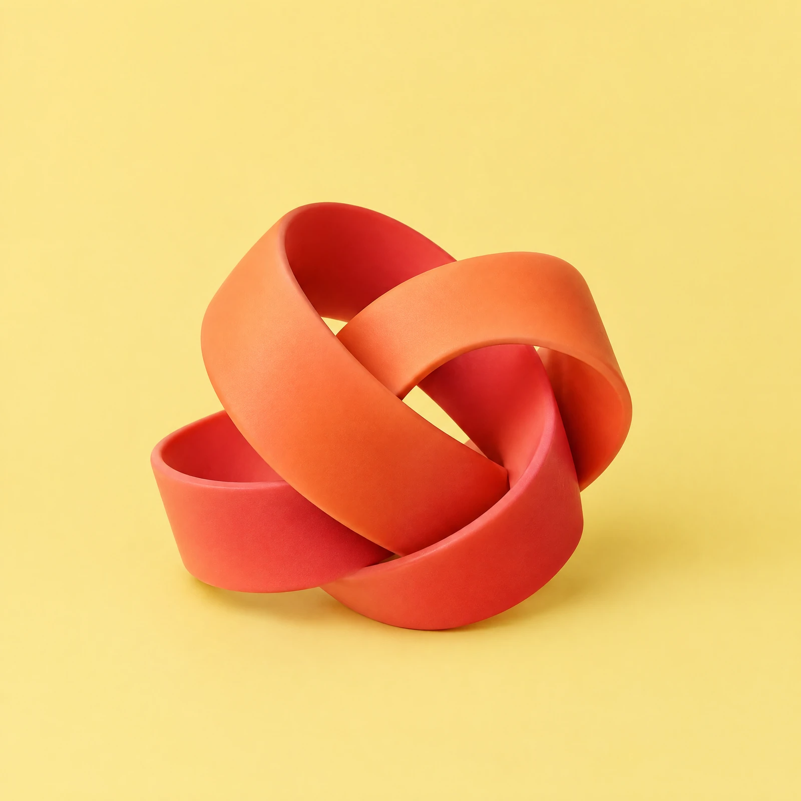 Coral and orange matte rubber ribbon twisted into a knot on a butter yellow background